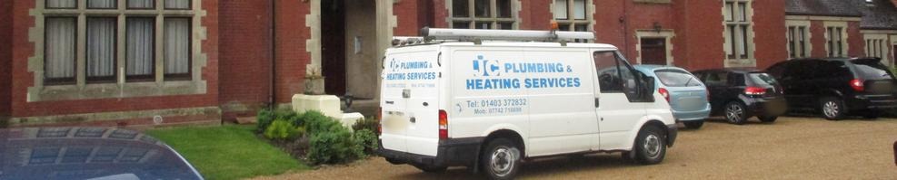 The van parked outside a large red-brick manor house